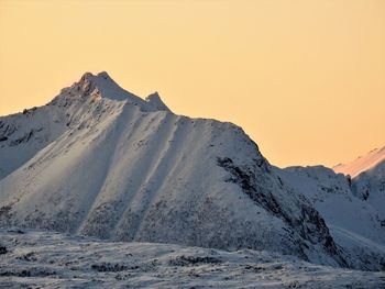 Scenic view of snowcapped mountains against clear sky during winter