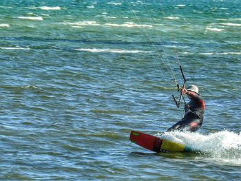 Man rowing boat in sea