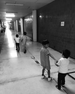 Rear view of people walking in corridor