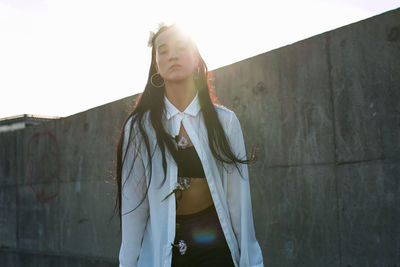 Portrait of young woman standing outdoors