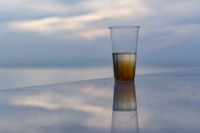 Close-up of beer against cloudy sky