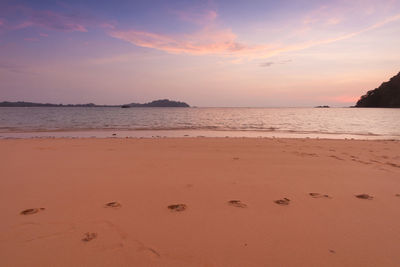 Scenic view of beach against sky during sunset