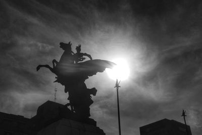 Low angle view of statue against cloudy sky