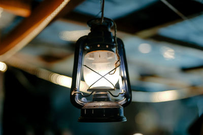 Close-up of light bulb hanging from ceiling