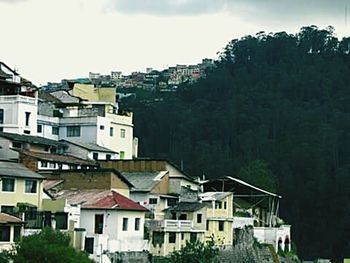 Houses in city against sky