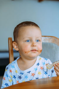 Portrait of cute baby boy sitting on table