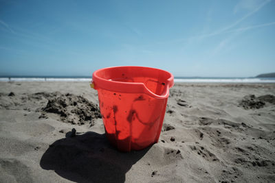 Close-up of red beach against blue sky