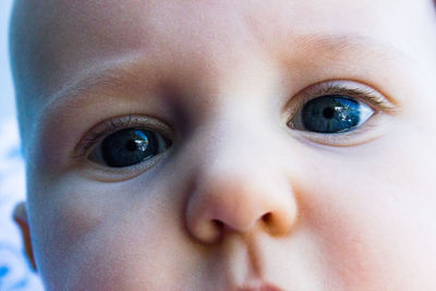 Close-up portrait of toddler with blue eyes