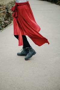 Low section of woman standing on street