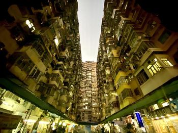 Low angle view of buildings in city at night