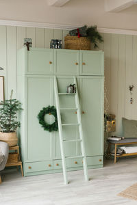 Mint-colored wardrobe in the interior of a bedroom decorated for christmas or new year