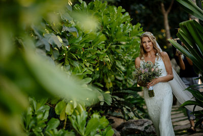 Woman standing amidst plants