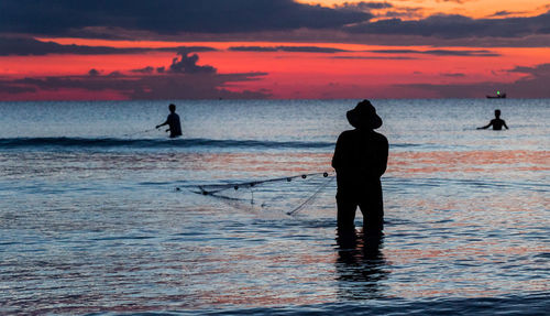 A fisherman is fishing at sunset on koh rong, cambodia