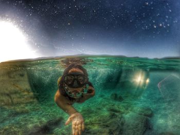 Low angle view of woman swimming in sea