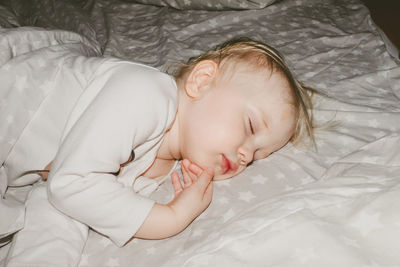 High angle view of baby sleeping on bed at home