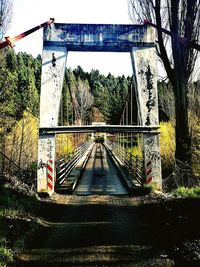 Railroad tracks by bridge against sky