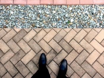 Low section of person on pebbles