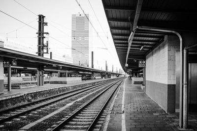 Train at railroad station platform against sky