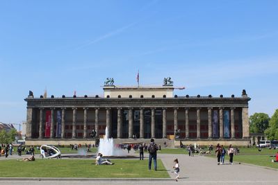 People in front of altes museum against clear blue sky