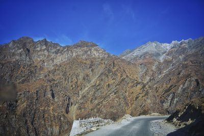 Scenic view of mountains against blue sky