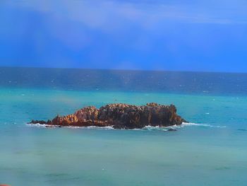 Scenic view of sea against blue sky