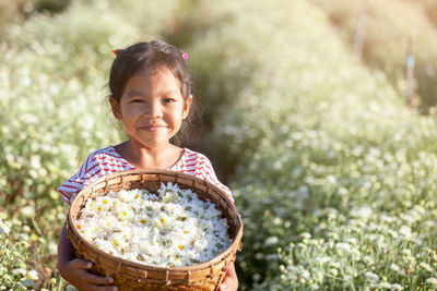 Portrait of smiling girl holding flower basket