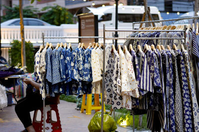 Clothes hanging for sale at market stall