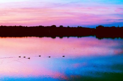 Scenic view of lake against sky at sunset