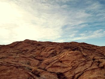 Scenic view of sand dunes against sky