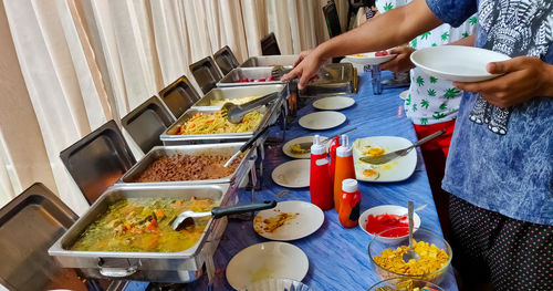 High angle view of man preparing food on table