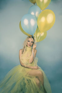 Portrait of a young woman with balloons