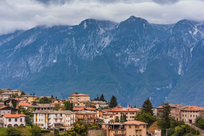 Townscape by mountains against sky