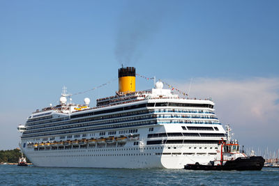 Low angle view of cruise ship on sea against blue sky