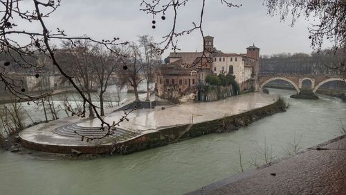 Bridge over river with buildings in background