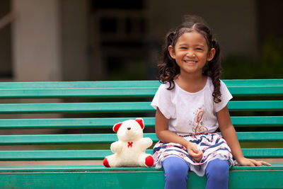 Portrait of a smiling girl with toy