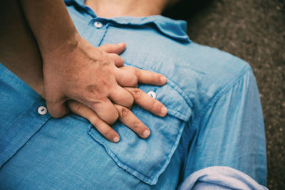 Midsection of man sitting on floor