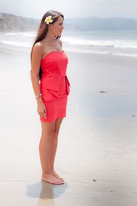 Full length of young woman standing on beach