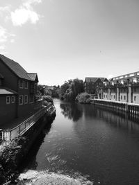 River amidst buildings against sky in city