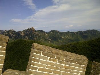 Steps leading towards mountain against sky