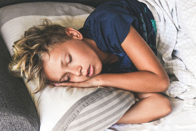 High angle view of baby sleeping on bed