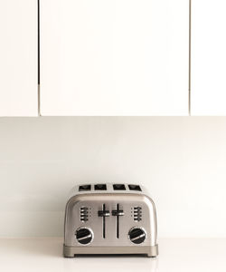 Close-up of clock on table at home