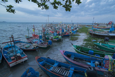 Boats moored in sea against sky