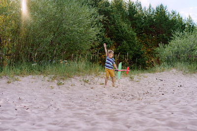 Rear view of woman walking on beach