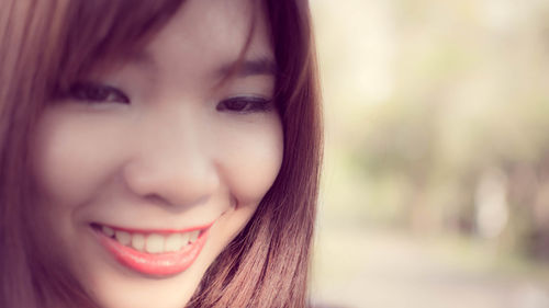 Close-up portrait of a smiling young woman