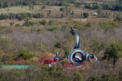 High angle view of machinery on field against trees