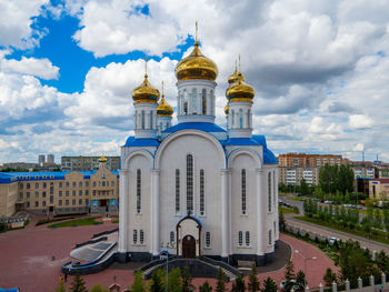 View of buildings against cloudy sky