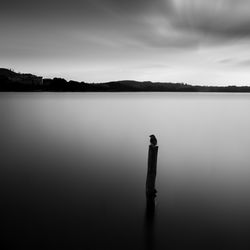 Scenic view of lake against sky at dusk
