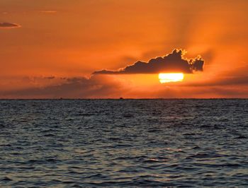 Scenic view of sea against orange sky