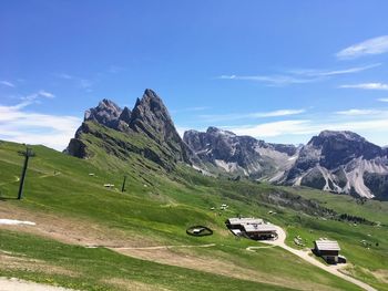 Cars on road by mountain against sky