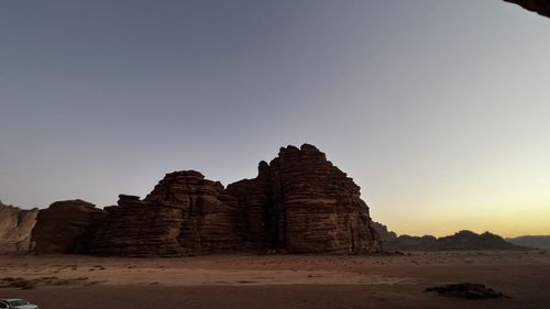 Ruins of rock formation against clear sky